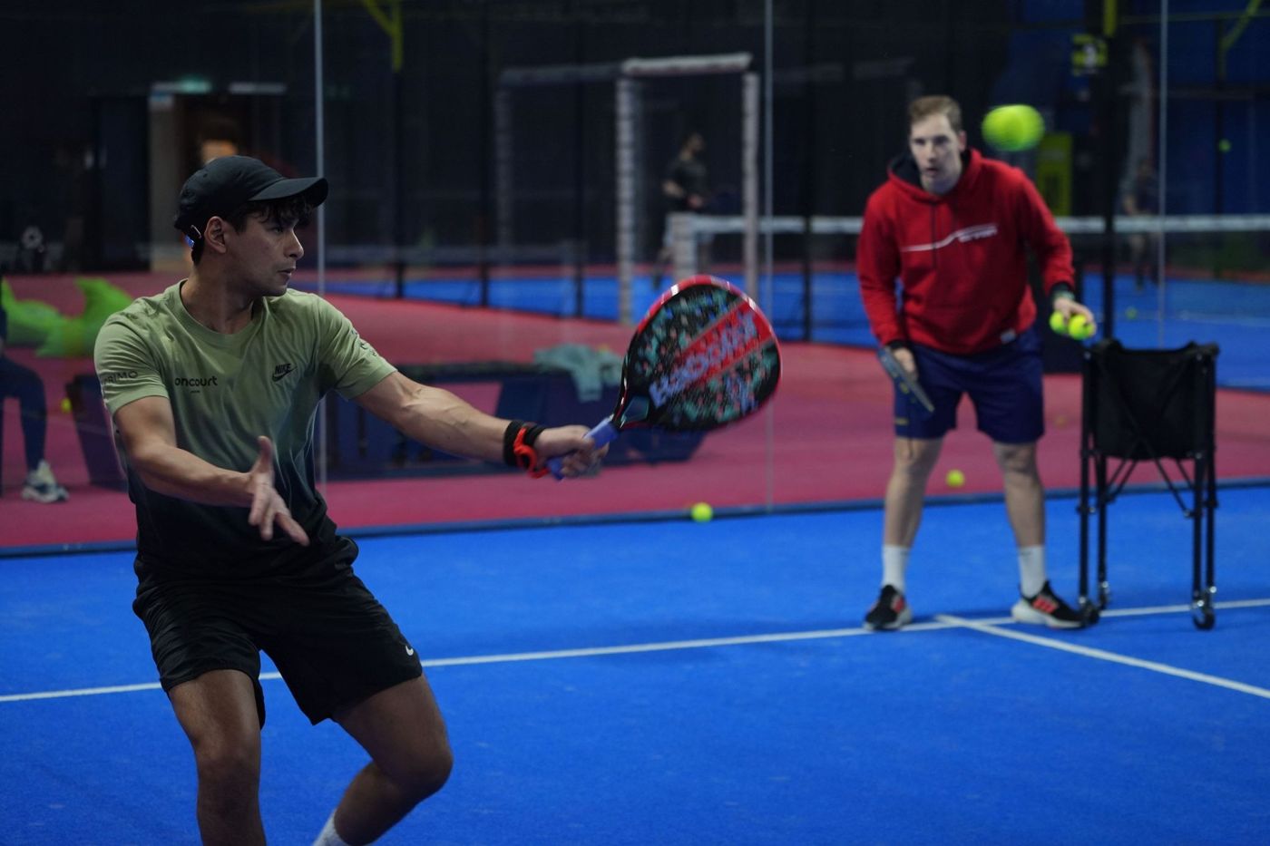Naser hitting a forehand during a drill session